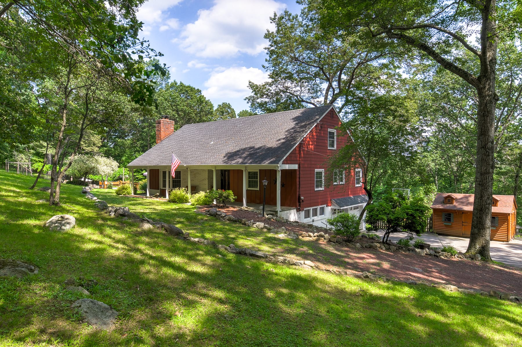 Rustic farmhouse home in Morris County NJ set on a wooded sloped property with private rural surroundings