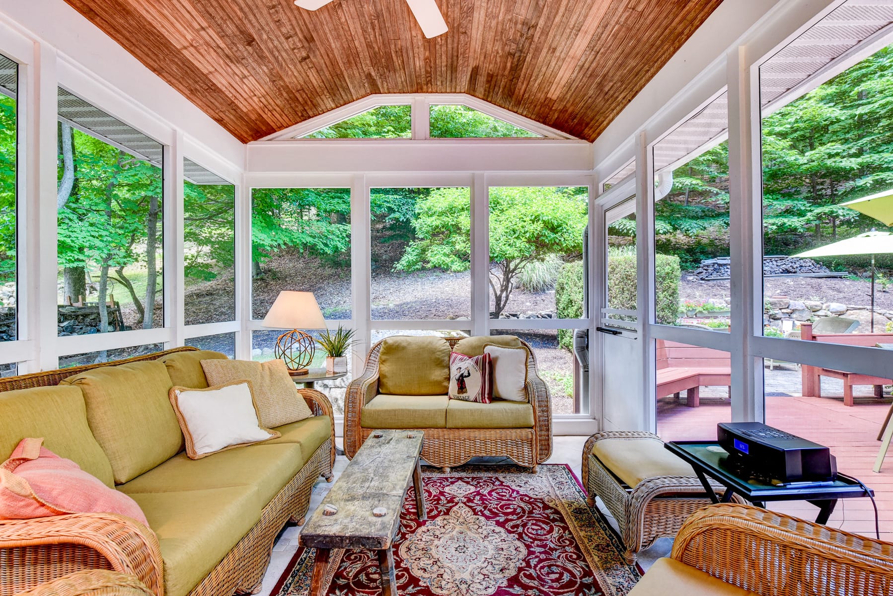 Sunroom in Morris County NJ with wood ceiling, large windows, and direct access to deck and patio overlooking backyard